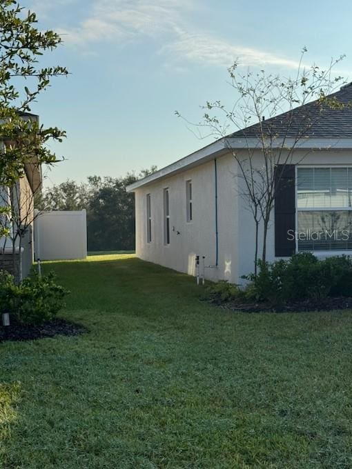 view of side of home featuring a yard