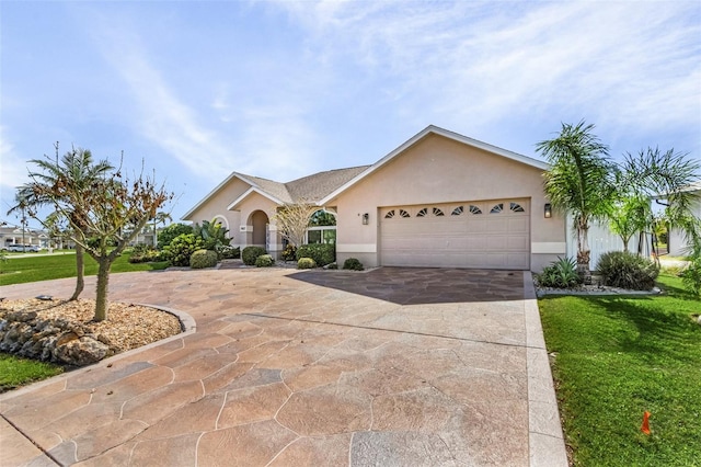 ranch-style house featuring a garage and a front lawn