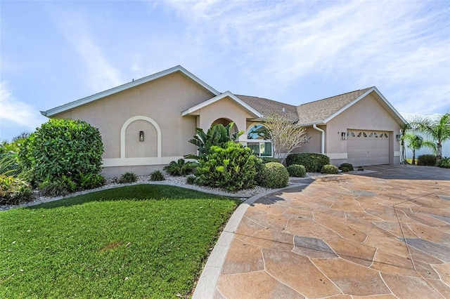 ranch-style house featuring a front lawn and a garage