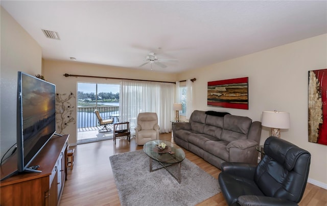 living room with ceiling fan and light wood-type flooring