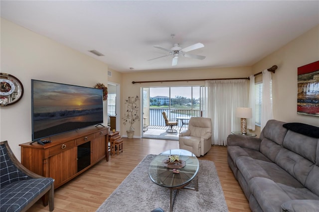 living room with light hardwood / wood-style flooring and ceiling fan