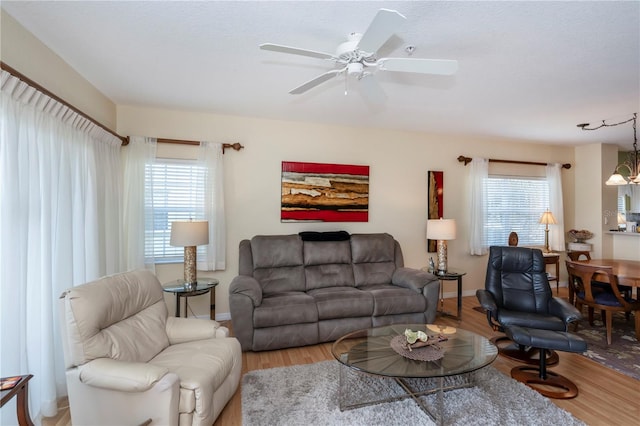 living room featuring hardwood / wood-style flooring, a healthy amount of sunlight, and ceiling fan