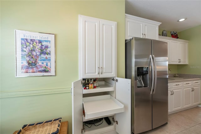 kitchen with white cabinetry and stainless steel refrigerator with ice dispenser