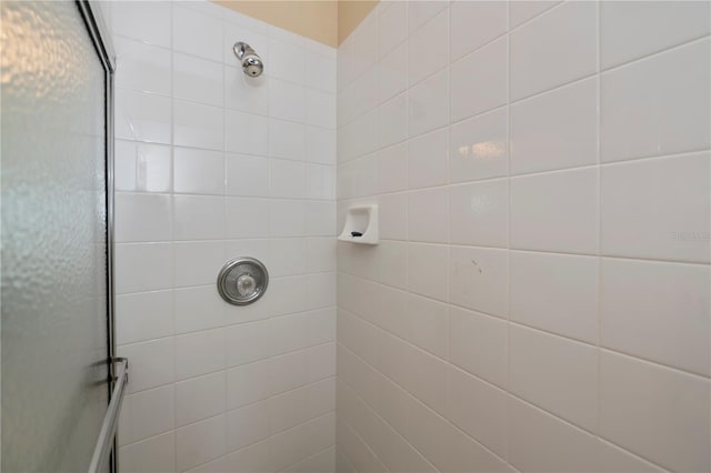 bathroom with tiled shower