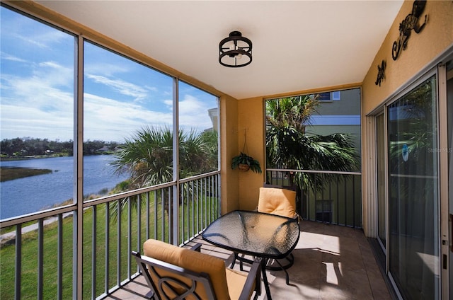 sunroom / solarium featuring a water view