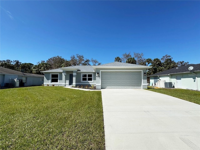 view of front of house featuring central AC, a garage, and a front lawn