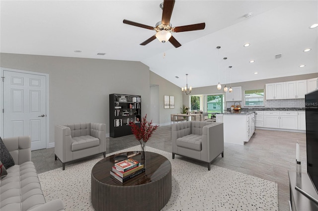 living room featuring lofted ceiling and ceiling fan with notable chandelier