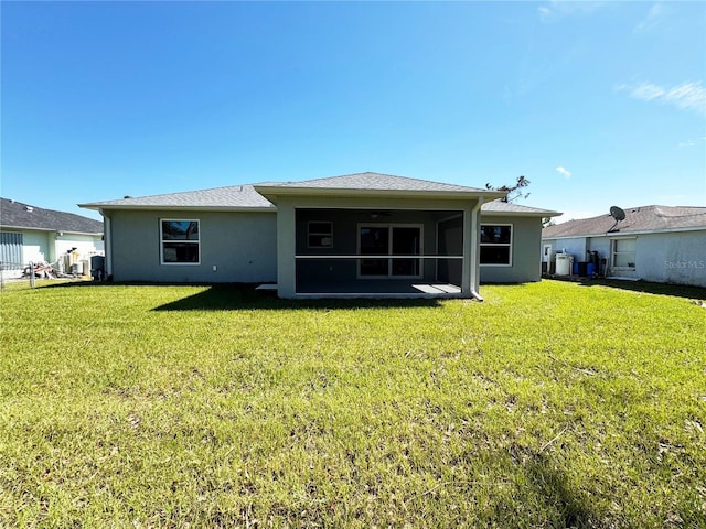 back of property featuring a lawn