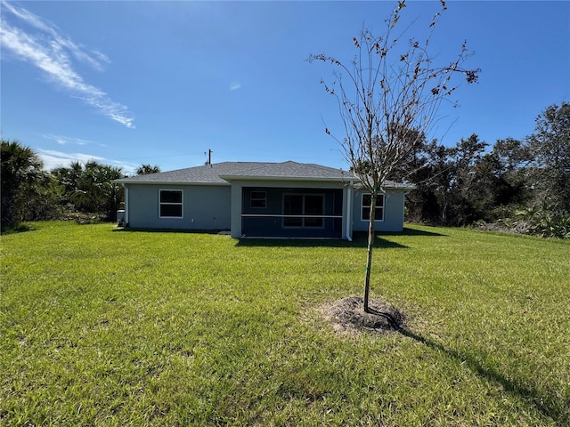 back of property featuring a lawn