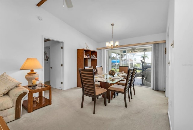 dining space featuring ceiling fan with notable chandelier, vaulted ceiling, and light colored carpet