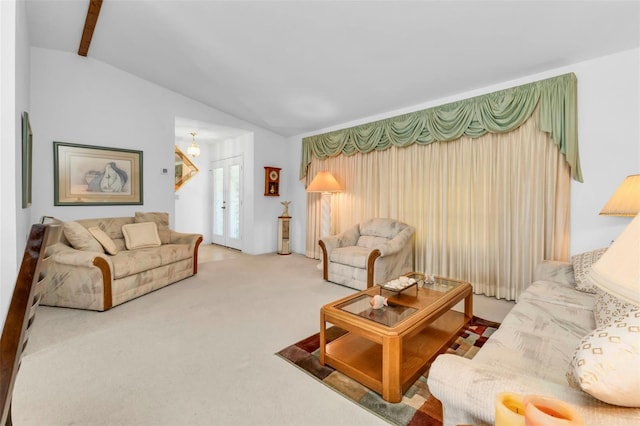 living room with an inviting chandelier, carpet, vaulted ceiling with beams, and french doors