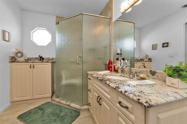 bathroom with vanity and an enclosed shower