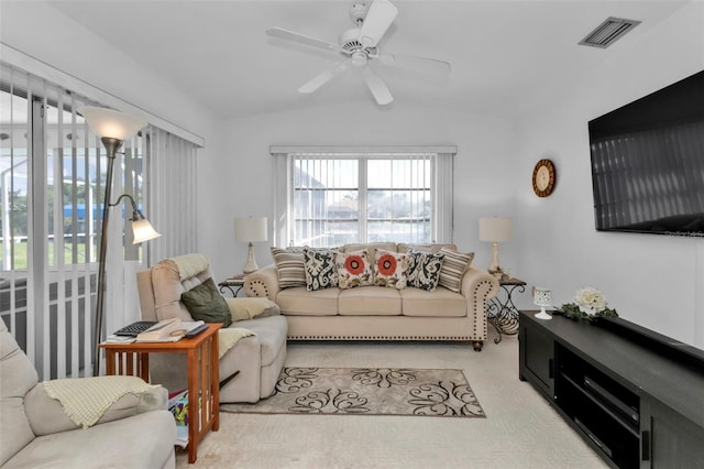 carpeted living room featuring ceiling fan and vaulted ceiling