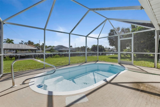 view of swimming pool featuring a lanai and a lawn