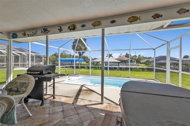 view of pool with a patio, a lanai, and a lawn