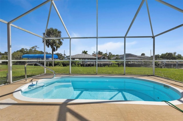 view of pool featuring a yard, a patio area, and a lanai