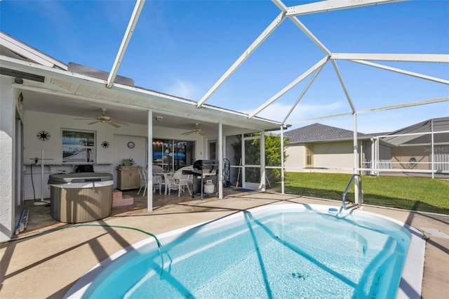 view of swimming pool with a patio area, a lanai, a yard, and ceiling fan