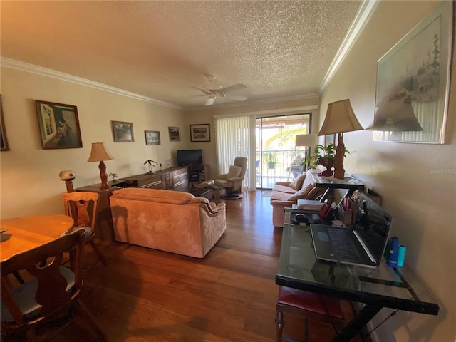 living room with ceiling fan, a textured ceiling, wood-type flooring, and ornamental molding