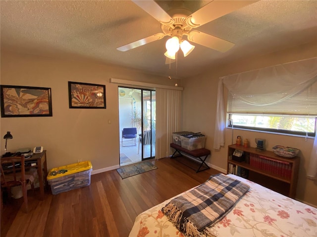 bedroom featuring ceiling fan, hardwood / wood-style flooring, a textured ceiling, and access to exterior