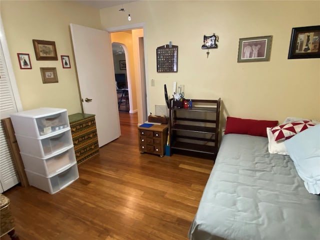 bedroom with dark hardwood / wood-style floors