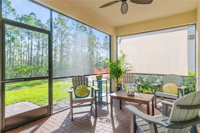 sunroom featuring ceiling fan