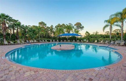 pool at dusk featuring a patio area