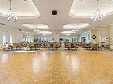 interior space featuring a raised ceiling, ornamental molding, and parquet flooring