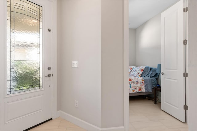 doorway with light tile patterned floors