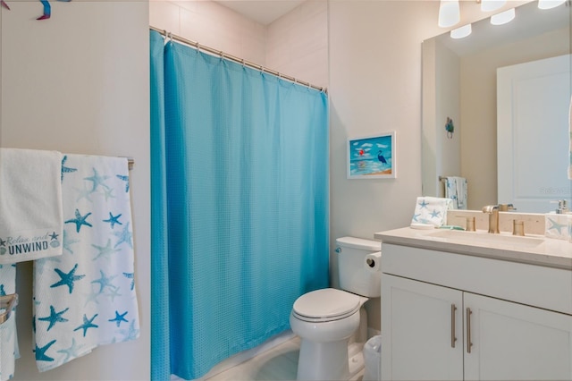 bathroom featuring vanity, toilet, and walk in shower