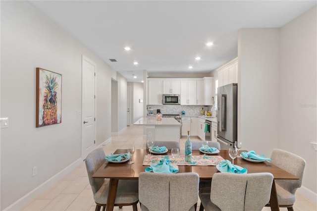 dining area featuring light tile patterned floors and sink