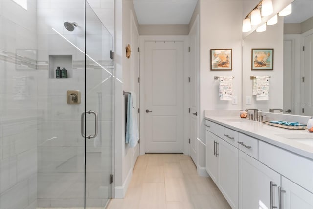 bathroom featuring vanity and a shower with shower door