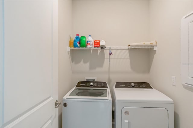 clothes washing area with washer and dryer