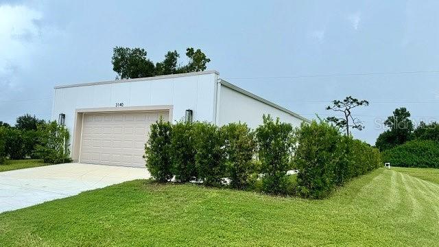 view of side of property with a garage and a yard