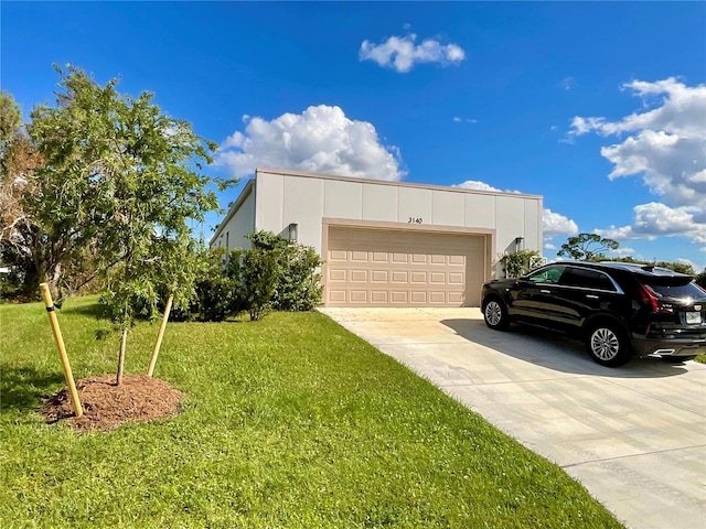 view of front of home with a front lawn and a garage