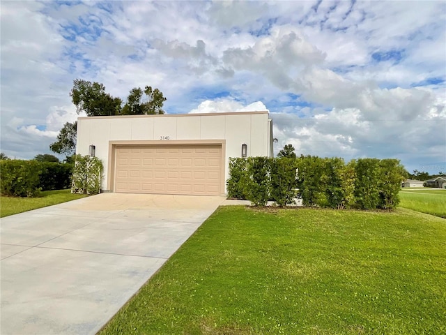 view of front of home with a front yard and a garage