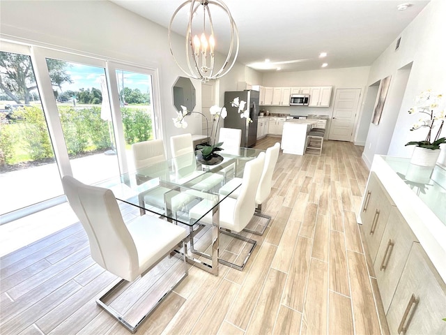 dining room featuring a chandelier and light wood-type flooring