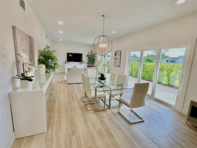 dining room featuring light hardwood / wood-style floors and an inviting chandelier