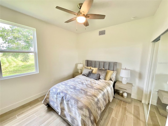 bedroom with a closet, ceiling fan, and light hardwood / wood-style flooring