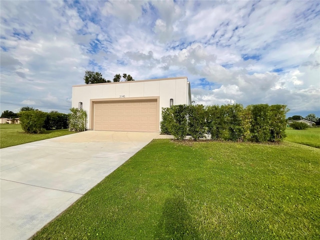 view of front of house with a garage and a front yard