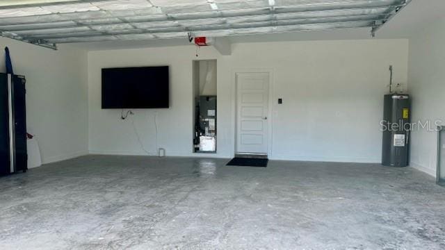 garage with water heater and black fridge