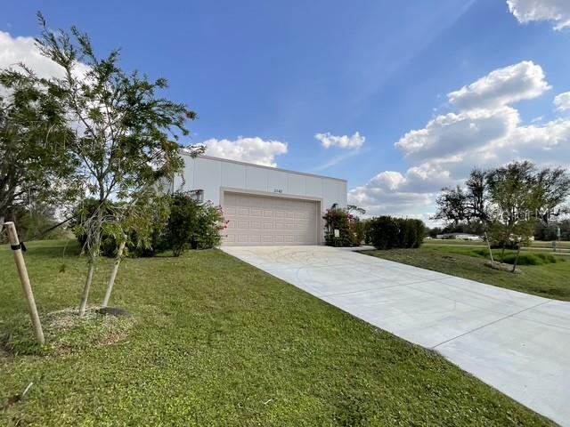 view of front of house with a garage and a front yard