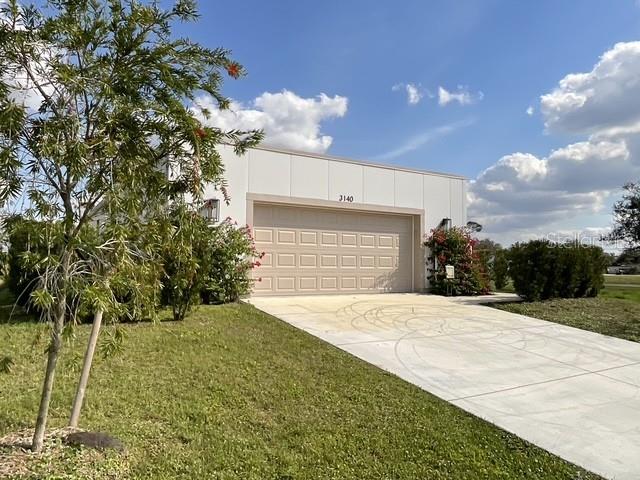 exterior space with a garage and a lawn