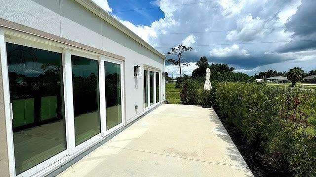 view of side of property with a patio area