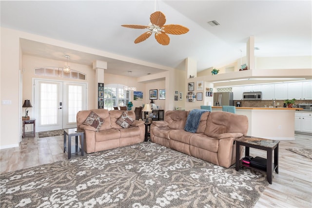 living room with french doors, high vaulted ceiling, light wood-type flooring, and ceiling fan