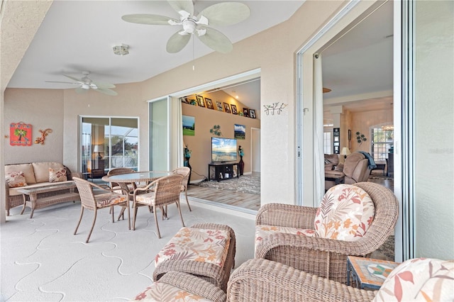 sunroom featuring ceiling fan and lofted ceiling