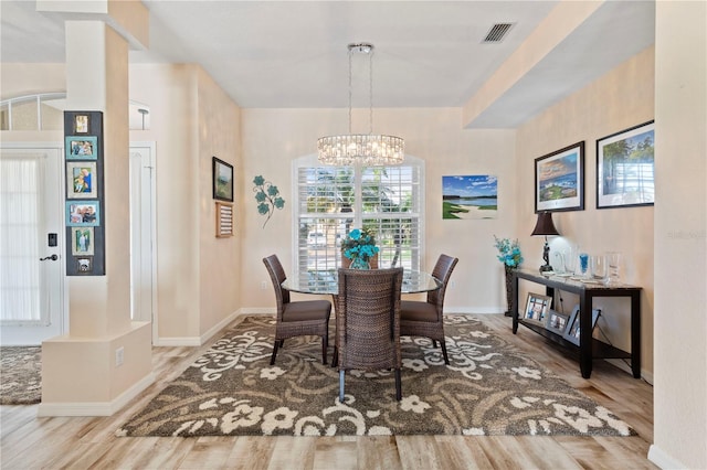 dining room with an inviting chandelier and light wood-type flooring