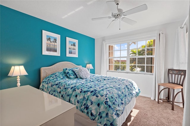 bedroom featuring light carpet and ceiling fan