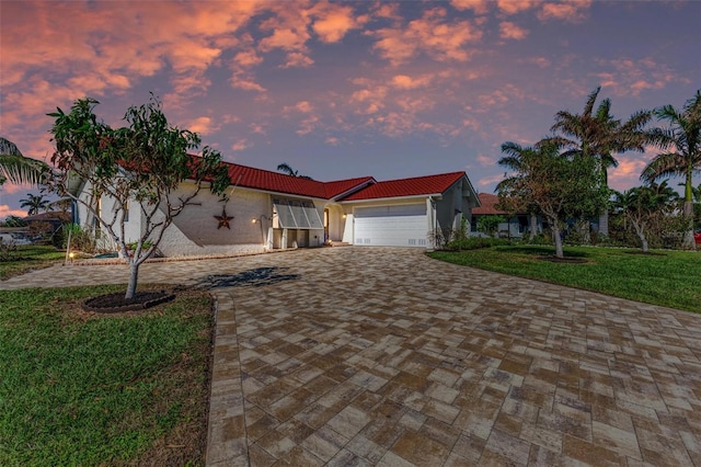 view of front of property with a lawn and a garage