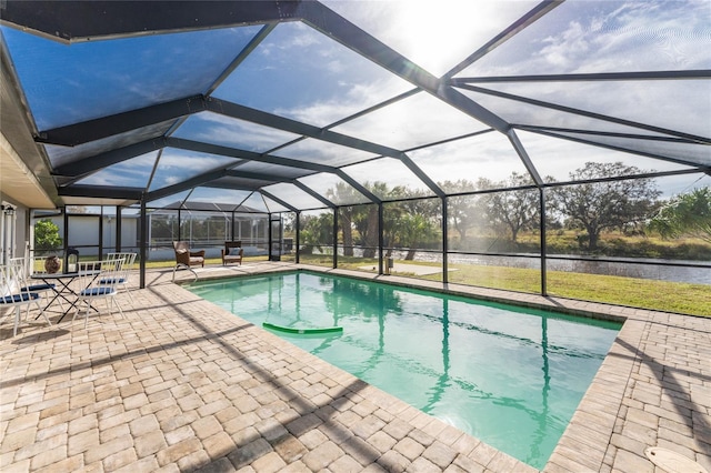 view of swimming pool with a patio and a lanai