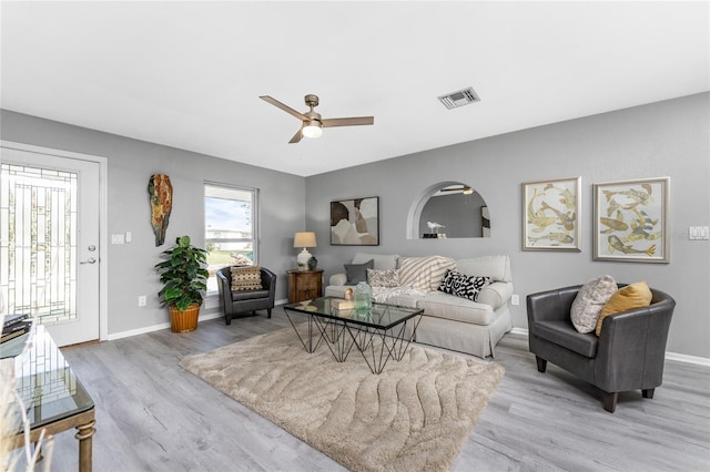 living room featuring light hardwood / wood-style flooring and ceiling fan